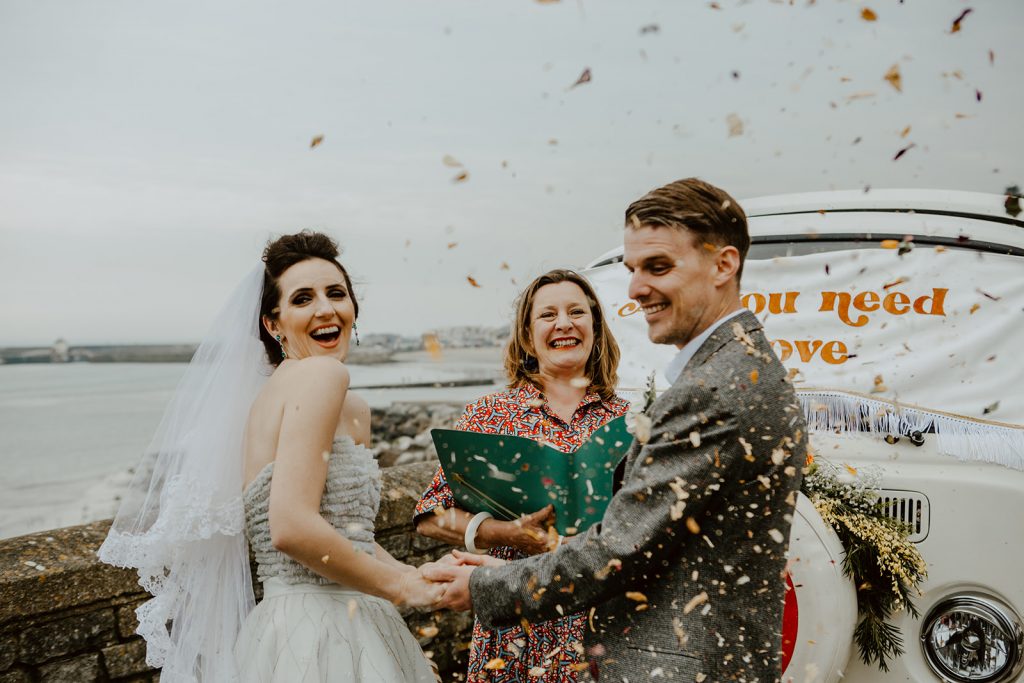 Wedding vows ceremony by the sea in Lyme Regis (South West of England).